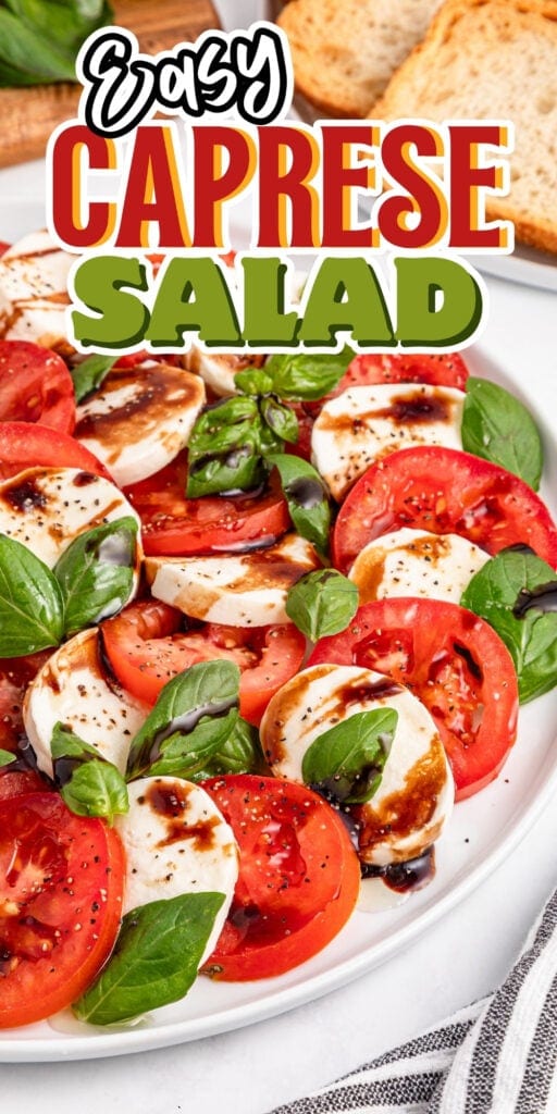 Sliced tomatoes, mozzarella, basil, balsamic drizzle on a white plate.