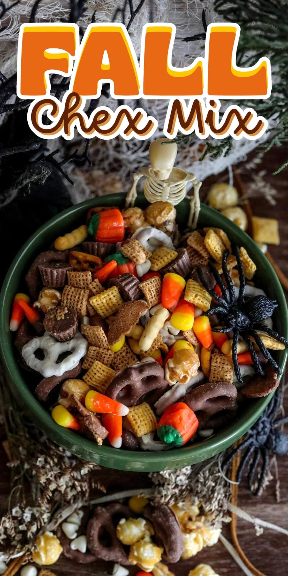 A bowl of fall Chex mix with candy corn, pretzels, and festive decorations.