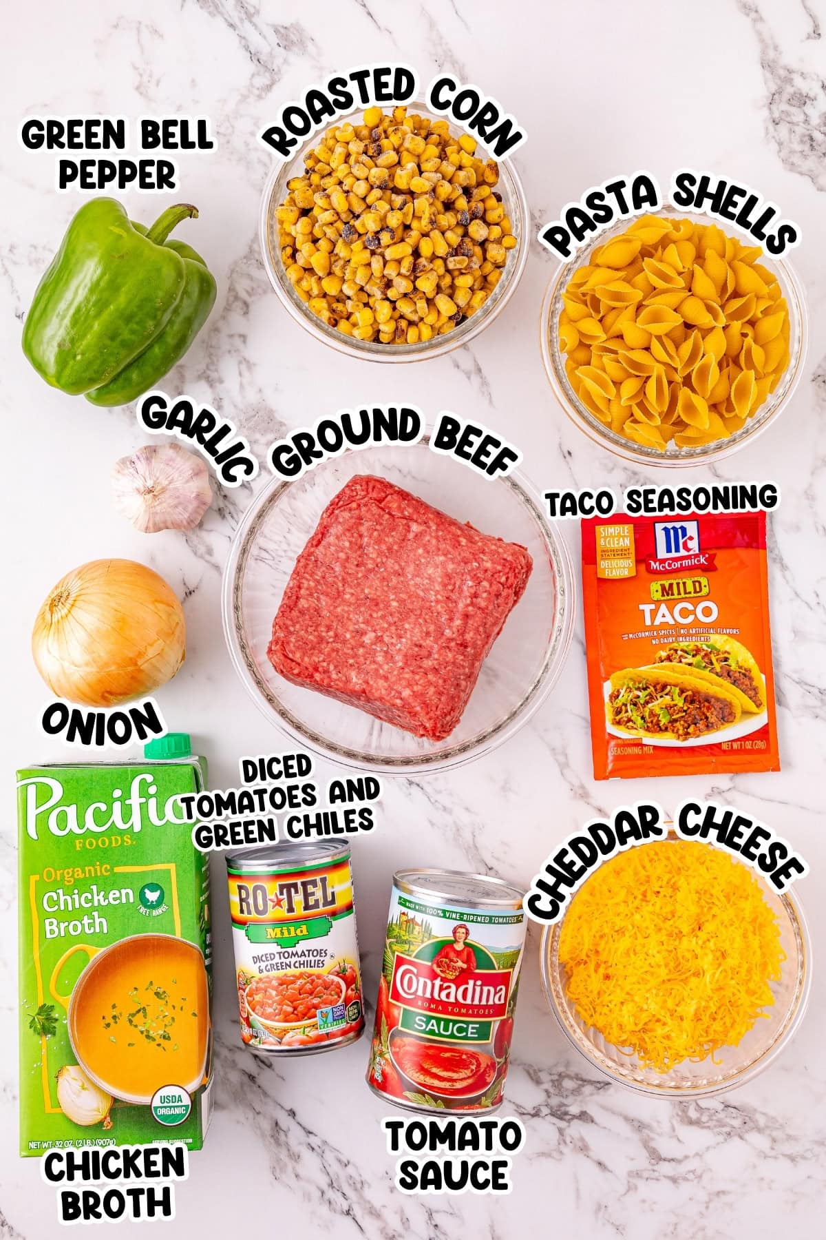Ingredients for taco pasta arranged on a counter.