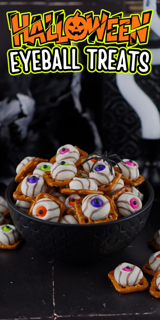 Bowl of Halloween-themed eyeball treats on pretzels with a toy spider.