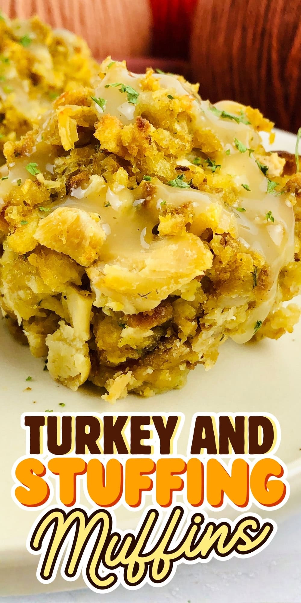 Turkey and stuffing muffins topped with gravy on a white plate.