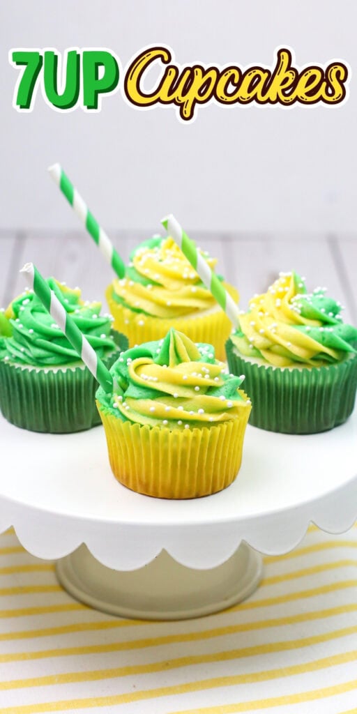 Green and yellow frosted cupcakes with straws on a white cake stand.