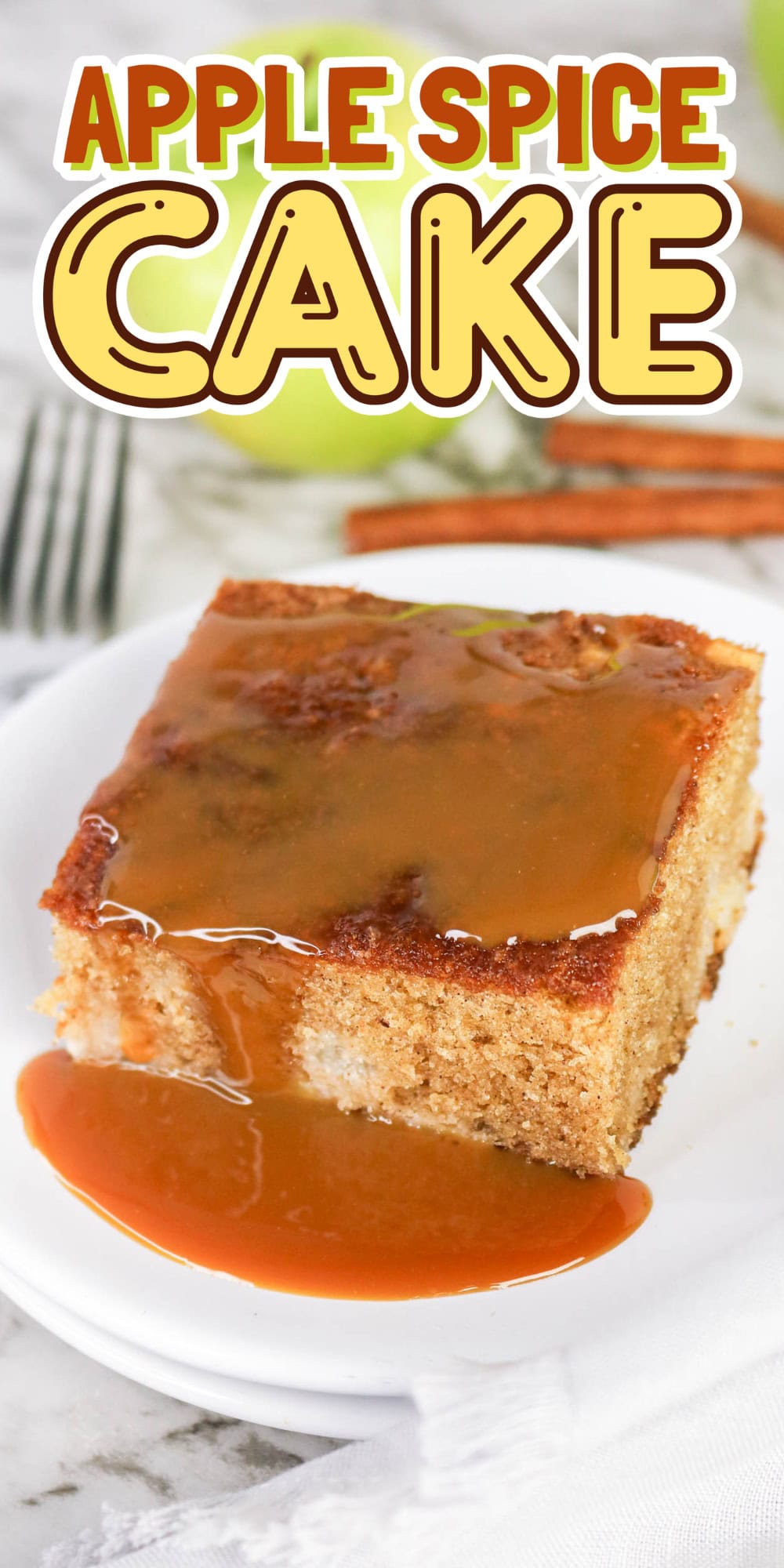 A slice of apple spice cake with caramel sauce on a white plate.