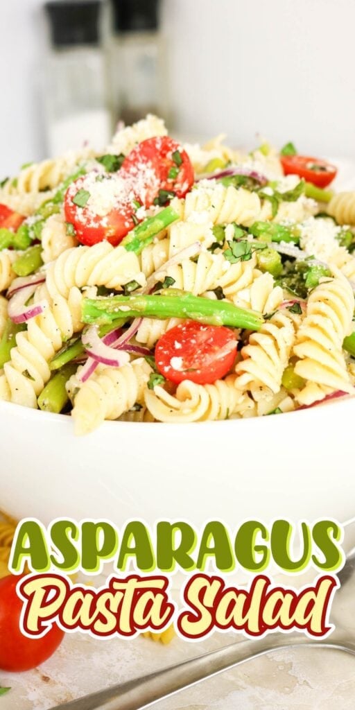 Bowl of pasta salad with asparagus, tomatoes, and parmesan cheese.
