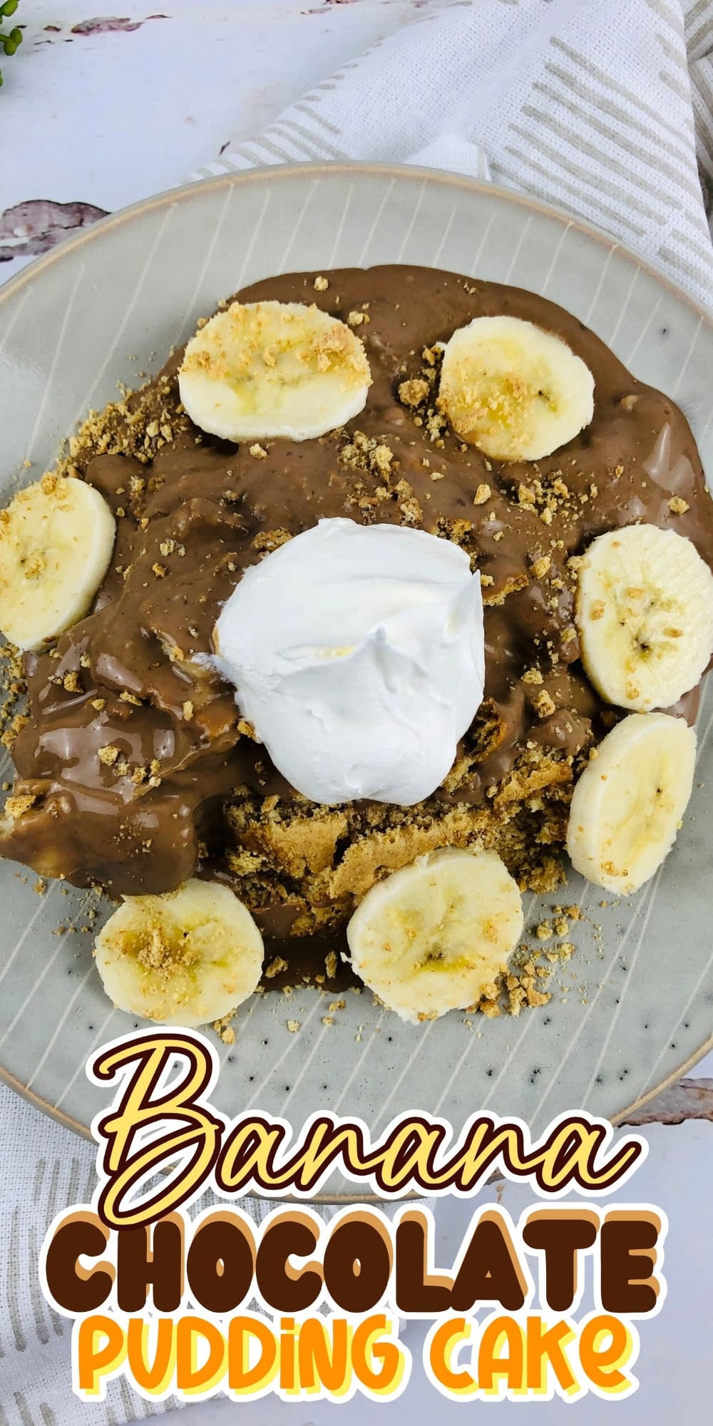 Banana chocolate pudding cake topped with whipped cream and banana slices.