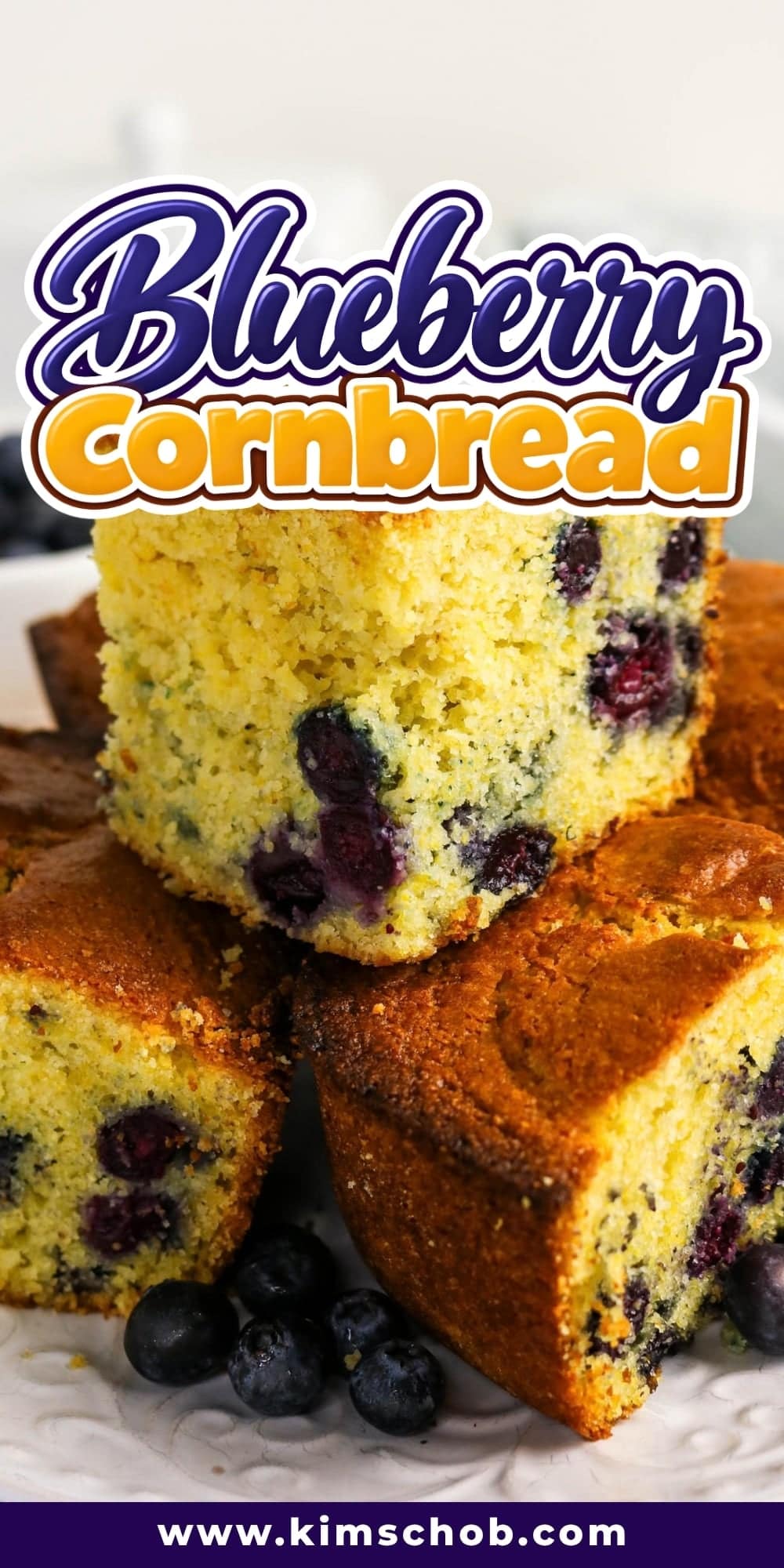 Thick slices of blueberry cornbread stacked on a white plate.