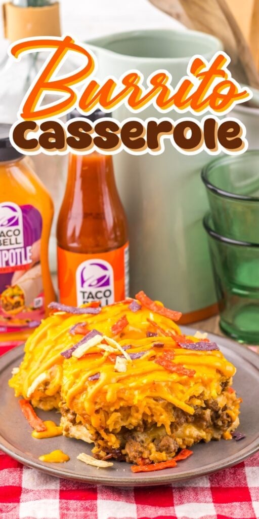 Burrito casserole on a plate with cheese, sauces, and colorful tortilla strips.