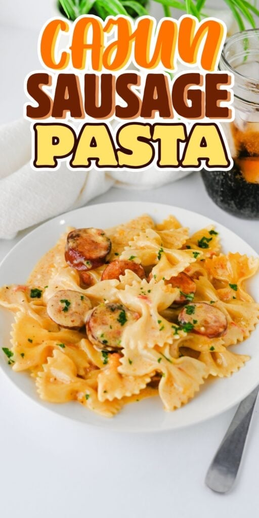 Plate of bowtie pasta with sausage, parsley, and a glass of soda nearby.
