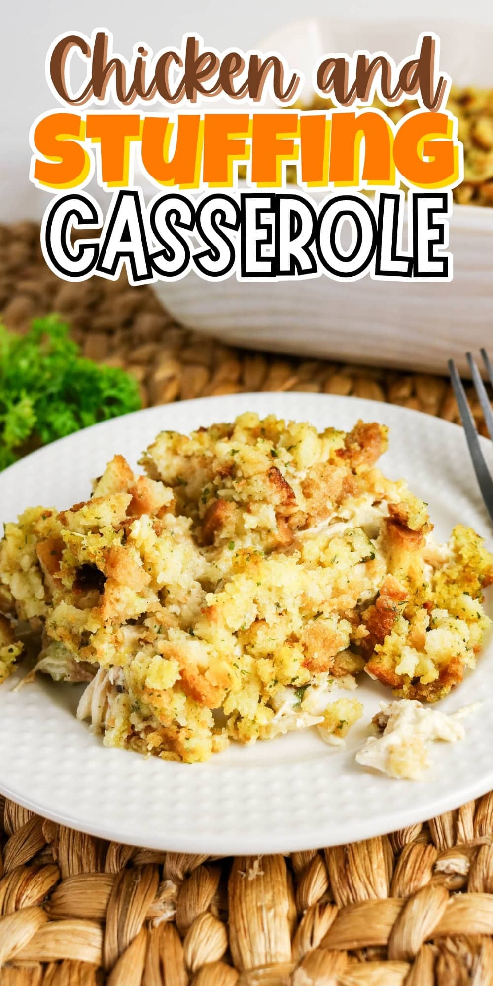 Chicken and stuffing casserole served on a white plate with a fork nearby.