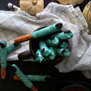 Pretzel fingers with green icing and black candy nails for Halloween.
