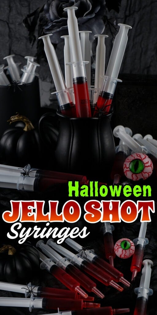 Black pitcher filled with red jello shot syringes, pumpkins, and fake eyeballs.