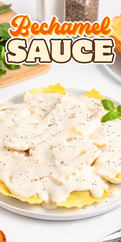 Ravioli on a plate topped with creamy béchamel sauce and black pepper.