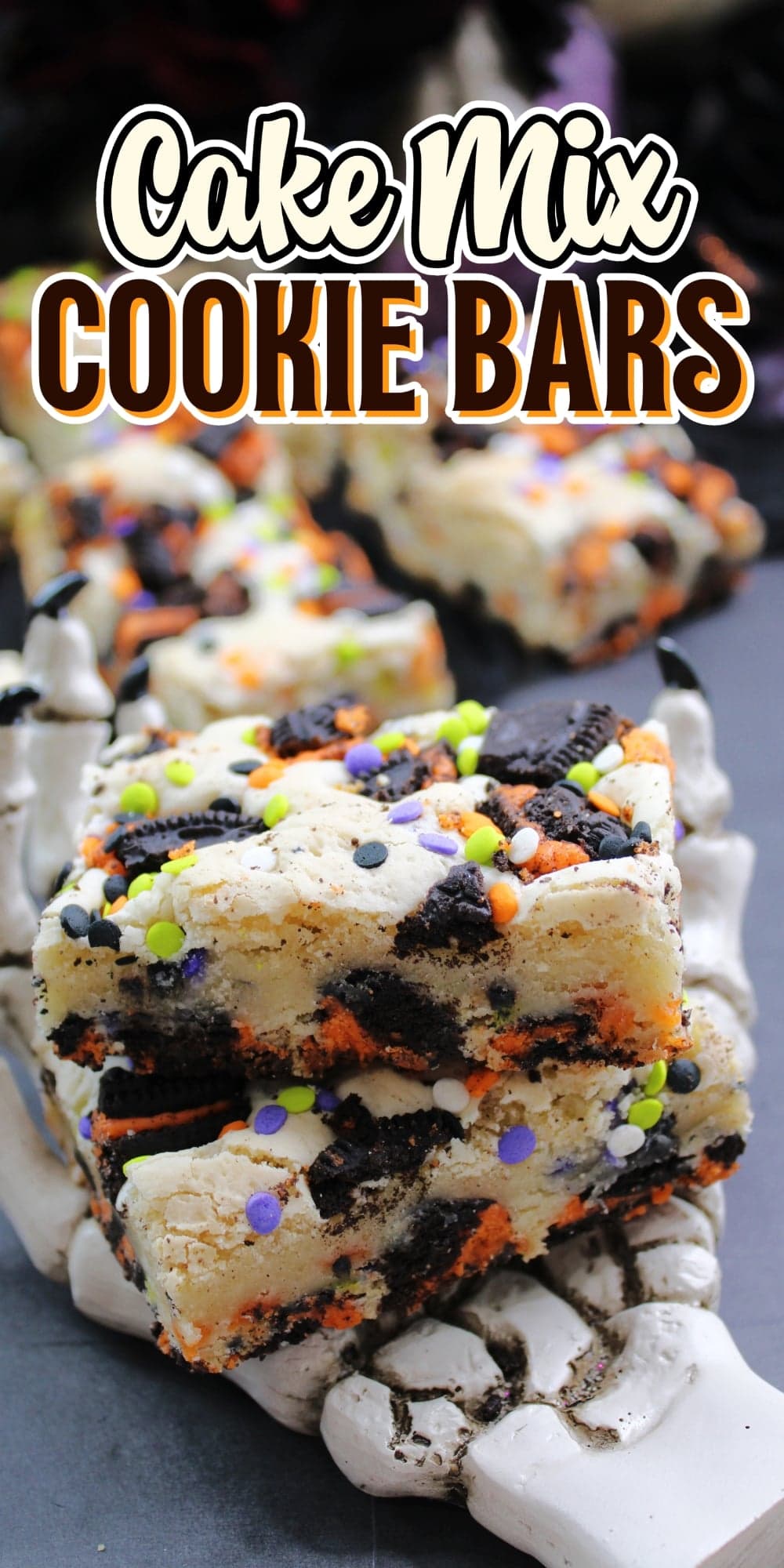 Blondie cookie bars with candy sprinkles on a white skeleton hand platter.