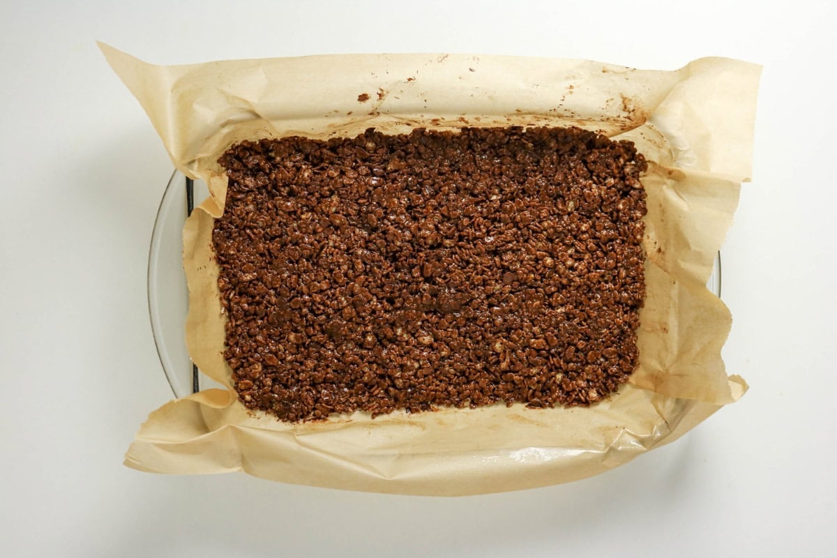Tray of chocolate oat bars on parchment paper, viewed from above.