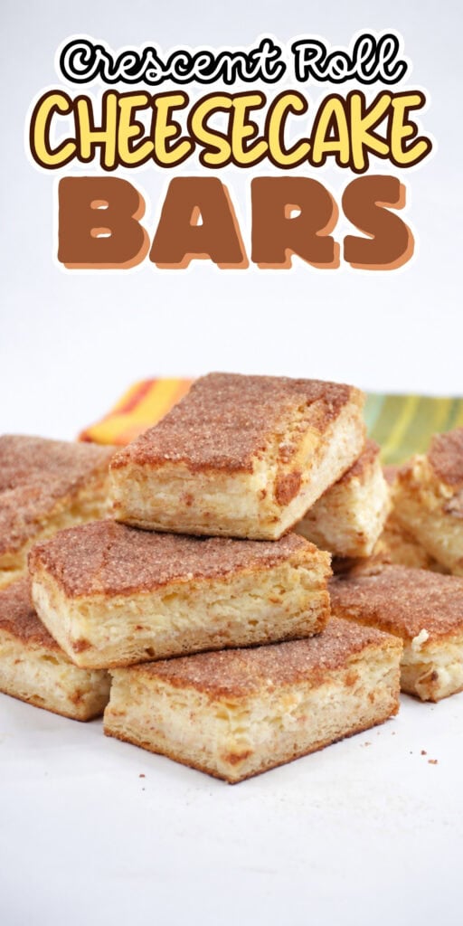 A stack of cinnamon sugar cheesecake bars on a white surface.