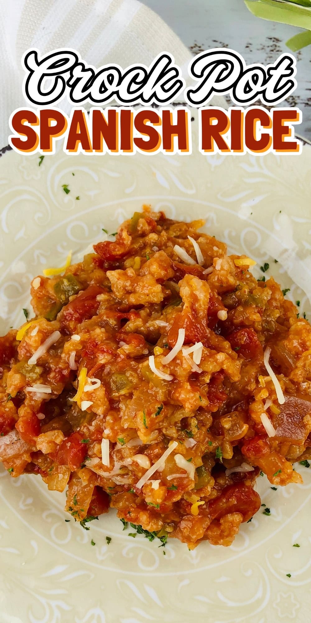 A plate of crock pot Spanish rice topped with shredded cheese.