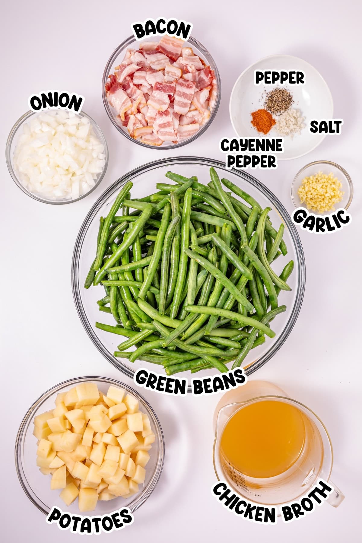 Bowls of green beans, bacon, potatoes, onion, garlic, spices, and chicken broth.