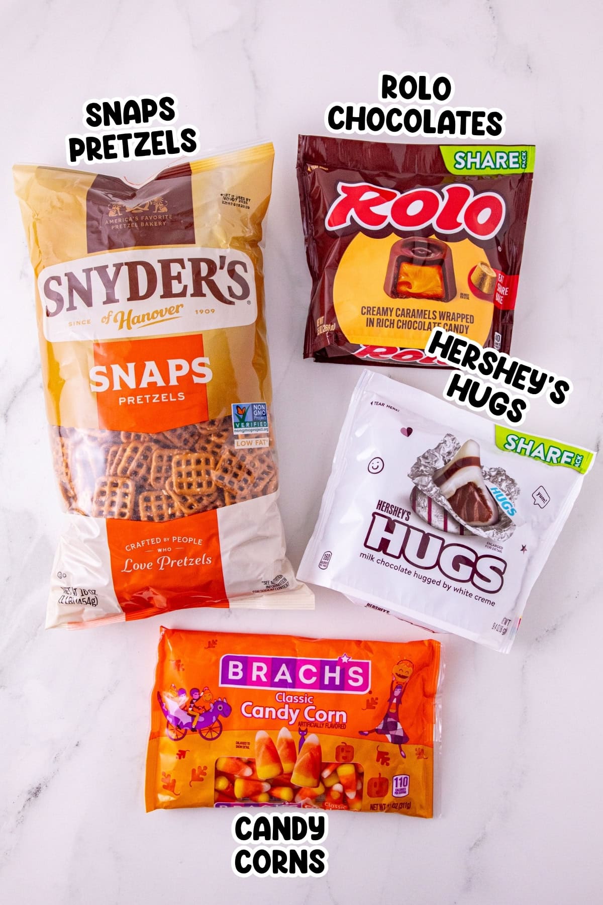 Four bags: pretzels, Rolo chocolates, Hersheys Hugs, and candy corn.