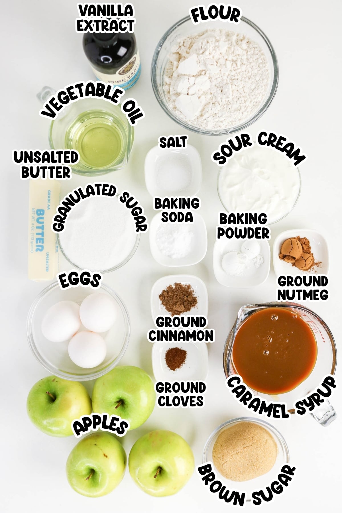 Baking ingredients for apple cake arranged on a white background.