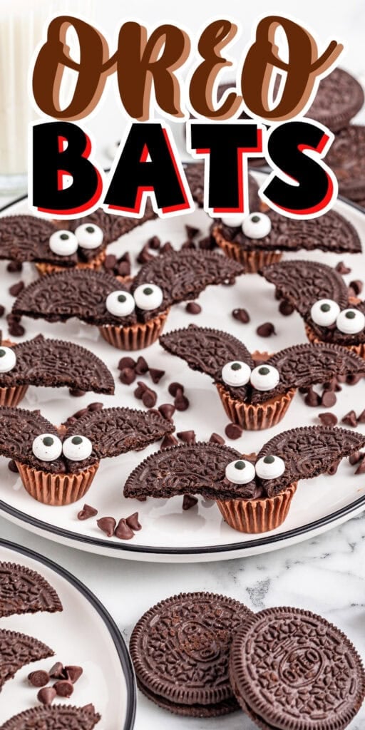Chocolate cupcakes with Oreo cookie bat wings and candy eyes on plates.