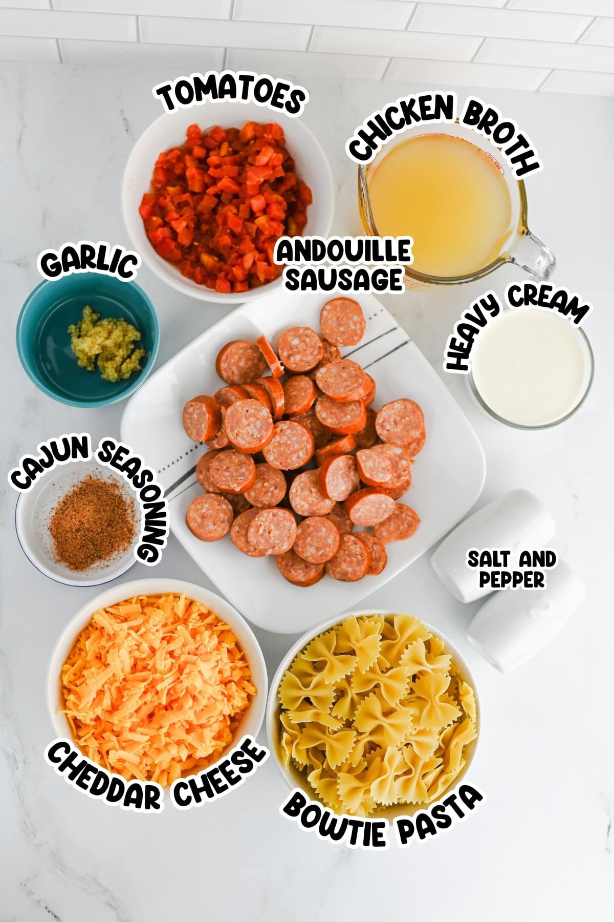 Bowtie pasta, sausage, cheese, broth, cream, tomatoes, garlic, and seasonings.