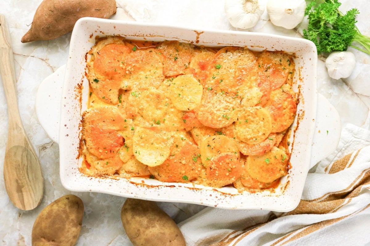 Cheesy scalloped sweet and regular potatoes, baked to perfection.