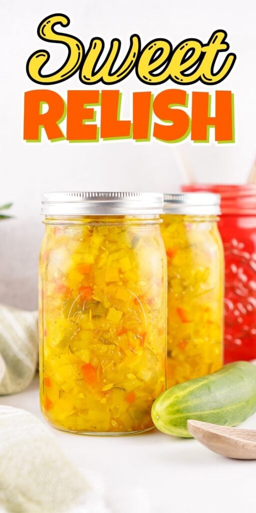 Jar of sweet relish with cucumber and red jar in the background.