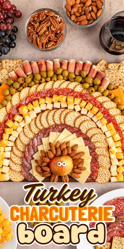 Turkey-shaped charcuterie board with meats, cheeses, crackers, and nuts.