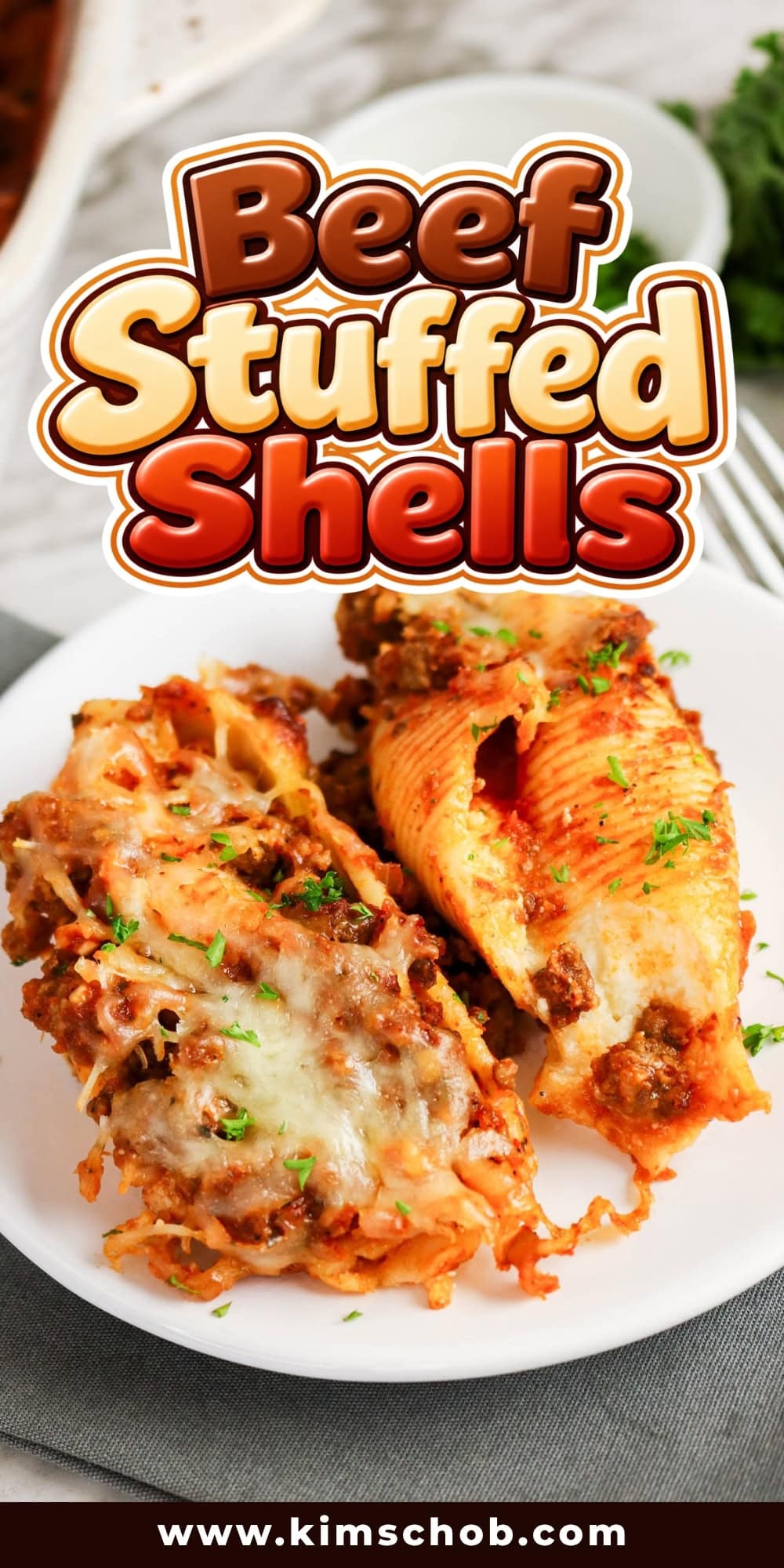 Two beef-stuffed pasta shells on a white plate.