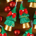 Chocolate Hersheys Kisses wrapped in green and gold foil shaped like trees.