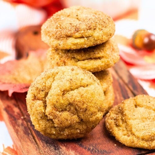 A stack of cinnamon sugar cookies on a wooden board.