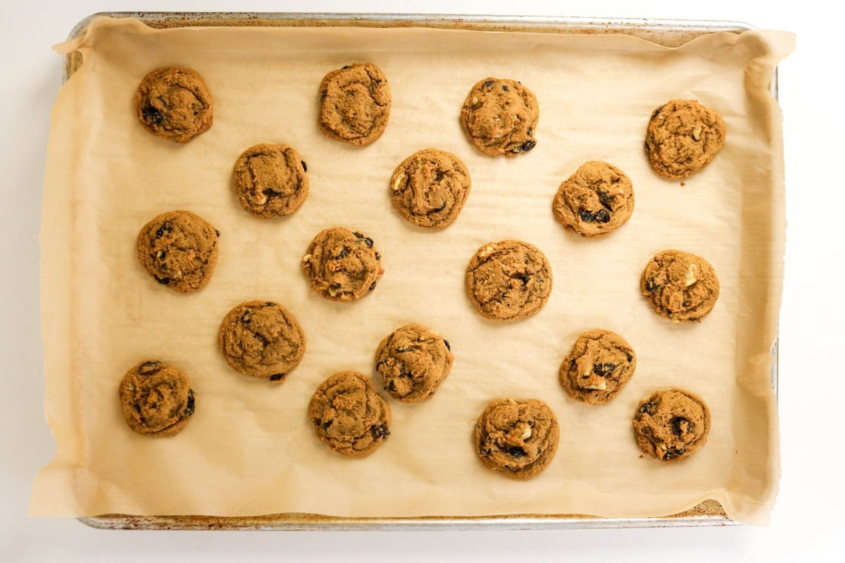 Fifteen cookies on a parchment-lined baking sheet.