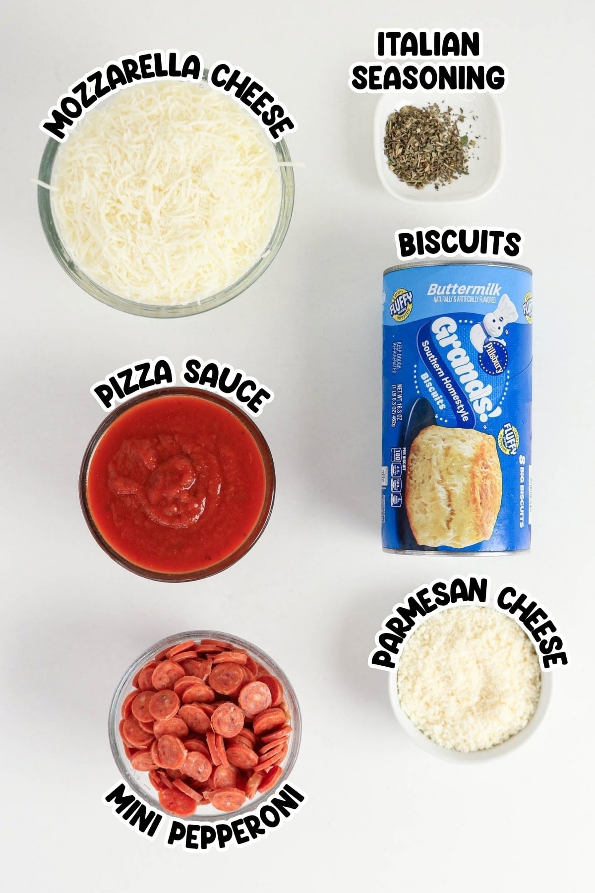 Ingredients for pizza biscuits including cheese, sauce, pepperoni, and dough.