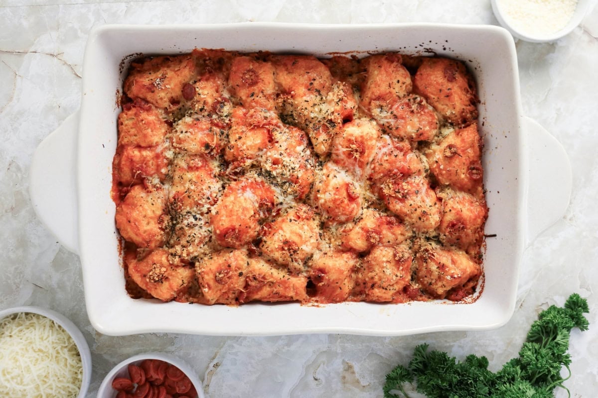 Baked pizza-style dough bites in a rectangular casserole dish.