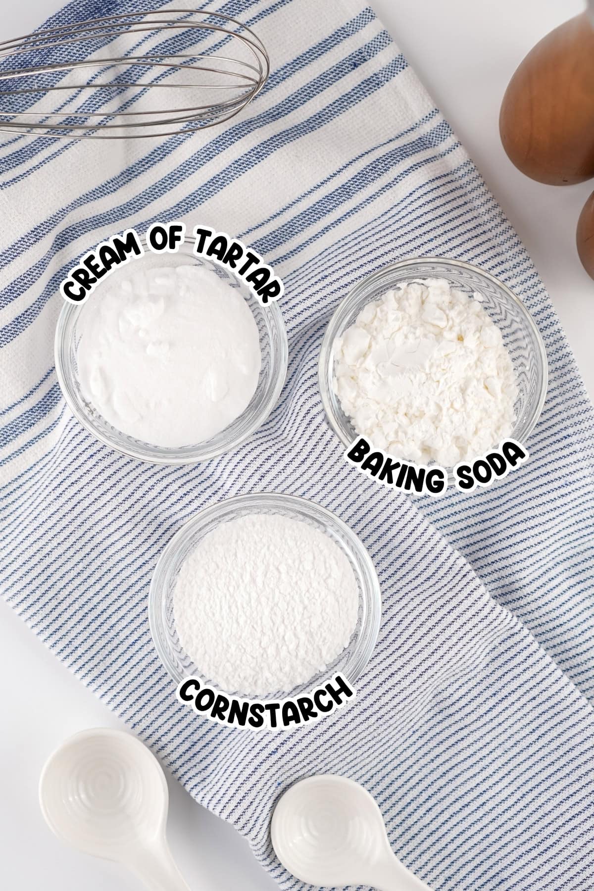 Three glass bowls labeled Cream of Tartar, Baking Soda, and Cornstarch.