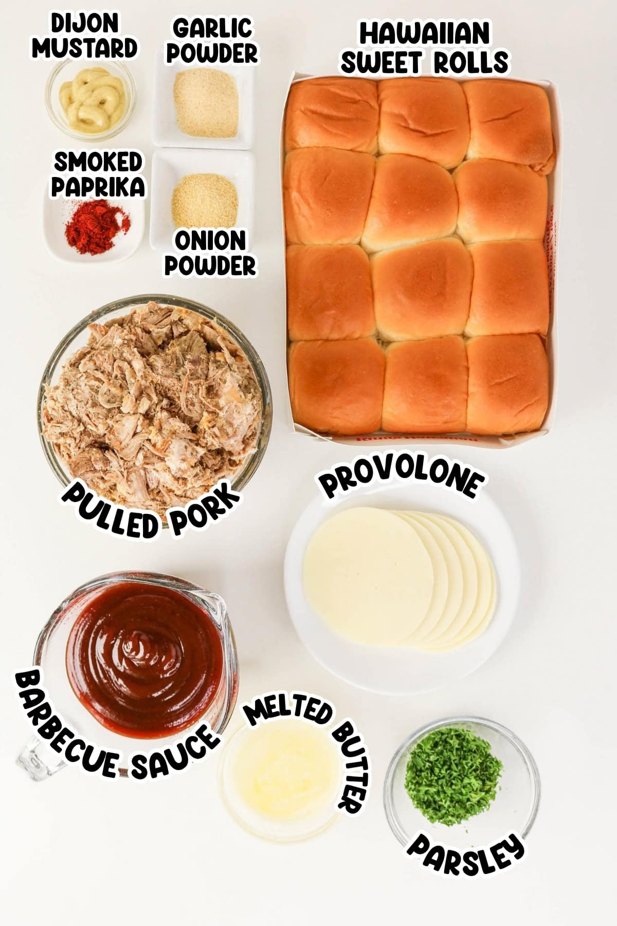 Ingredients for pulled pork sliders arranged neatly on a white surface.