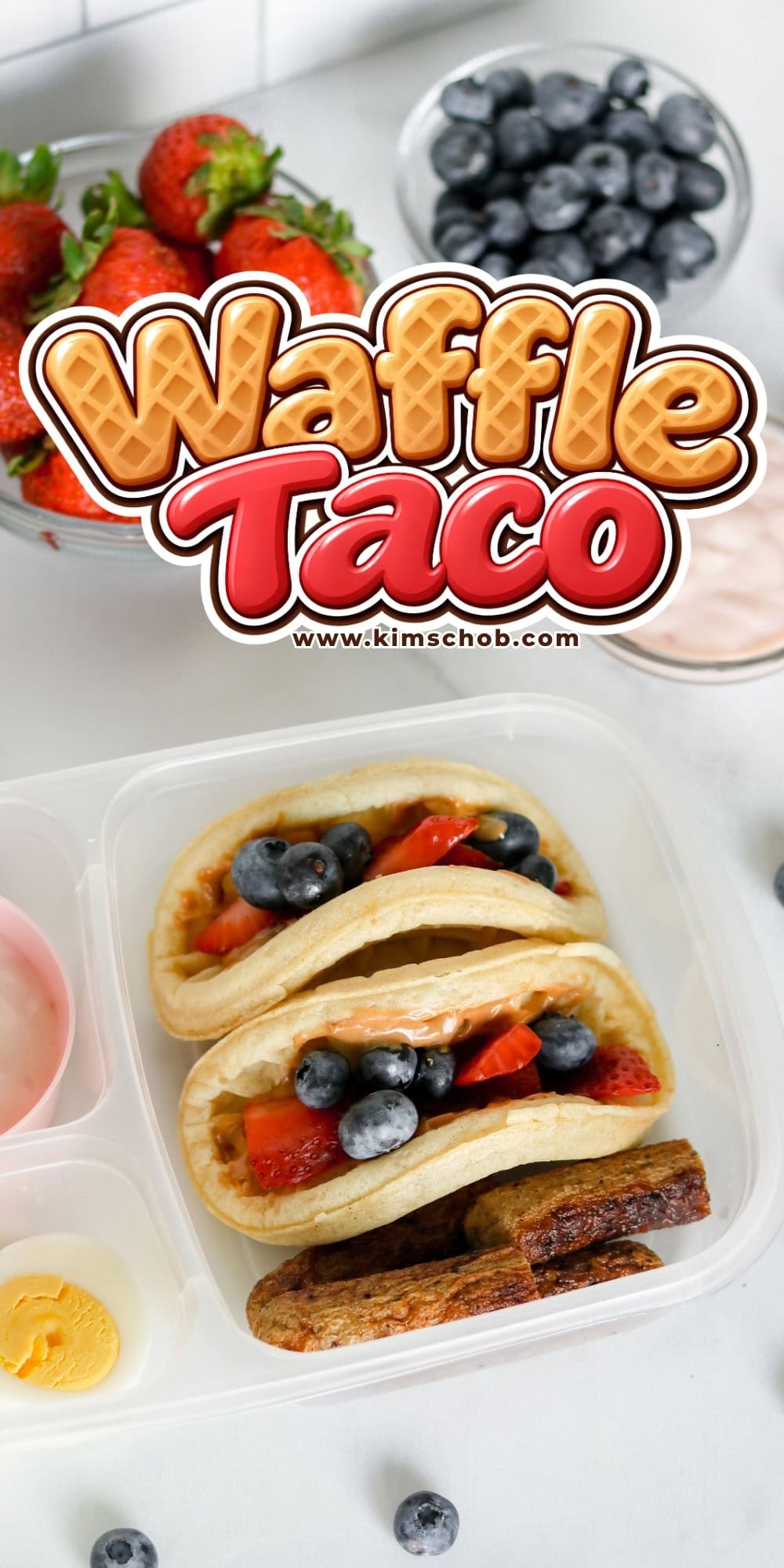 Waffle tacos with berries, boiled egg, sausage, and yogurt in a lunchbox.